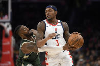 Milwaukee Bucks guard Wesley Matthews, left, reaches for the ball against Washington Wizards guard Bradley Beal (3) during the second half of an NBA basketball game, Monday, Feb. 24, 2020, in Washington. (AP Photo/Nick Wass)