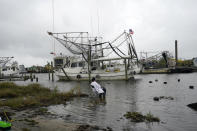 Minnie Lewis fishes for crabs before the wind and waves kick up, in Chalmette, La., Wednesday, Oct. 28, 2020. Hurricane Zeta is expected to make landfall this afternoon as a category 2 storm. (AP Photo/Gerald Herbert)