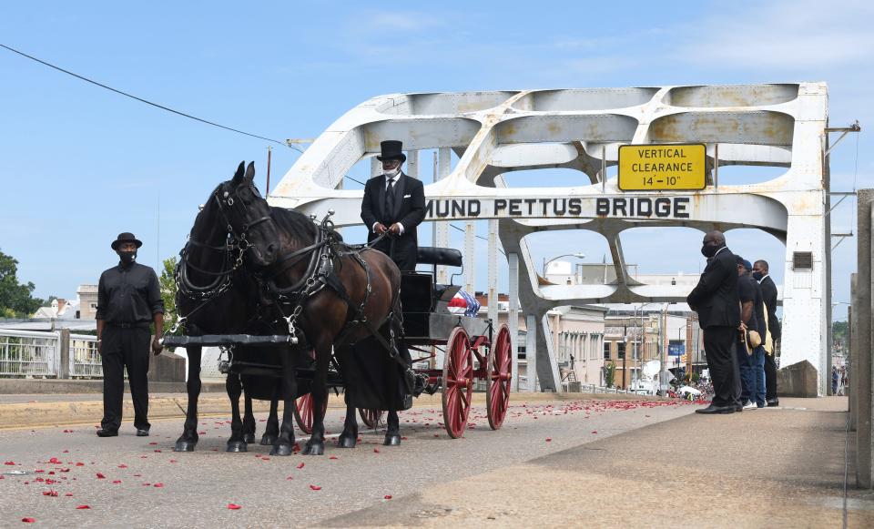 The body of civil rights icon and U.S. Rep. John Lewis is carried via horse-drawn carriage across the Edmund Pettus Bridge in Selma, Ala., on July 23, 2020.