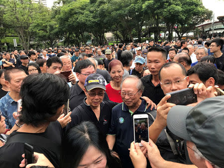 People crowd around former presidential candidate Tan Cheng Bock during a protest against the uncontested presidential election at Hong Lim Park in Singapore September 16, 2017. REUTERS/Fathin Ungku