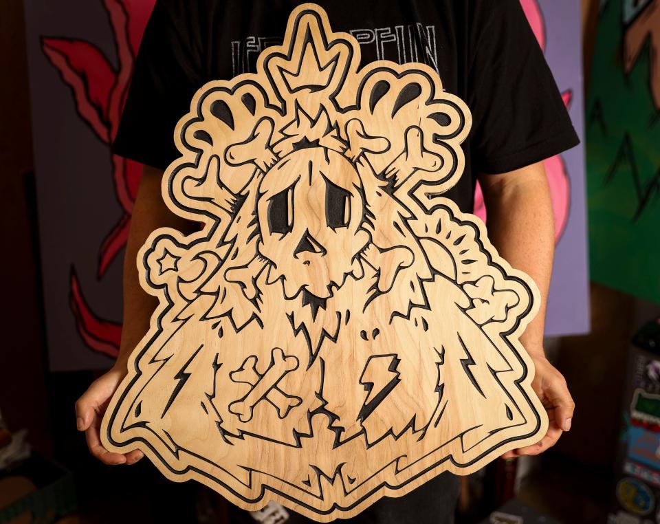 Jonezy's design is engraved and cut on a piece of wood at his studio on April 16 in Turner.