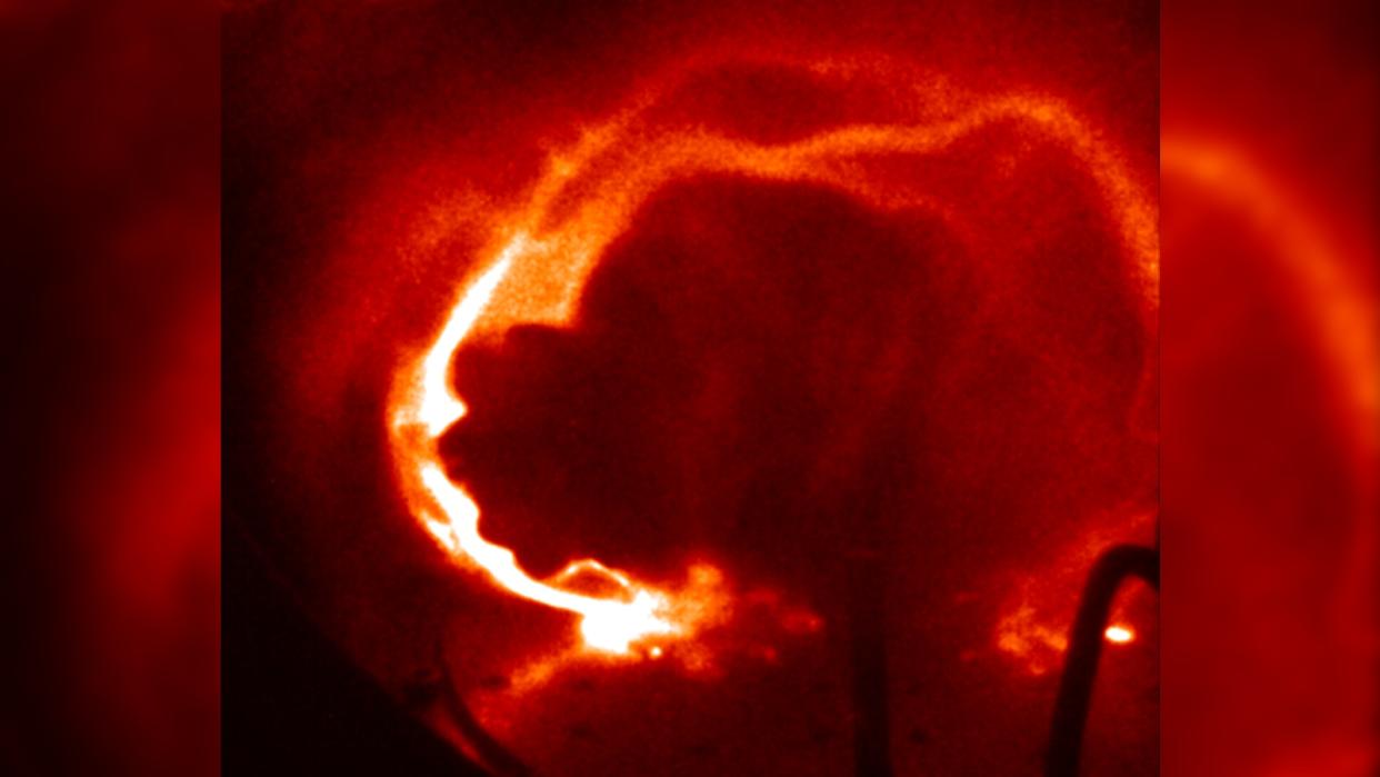  A close up of a fiery red loop of plasma. 