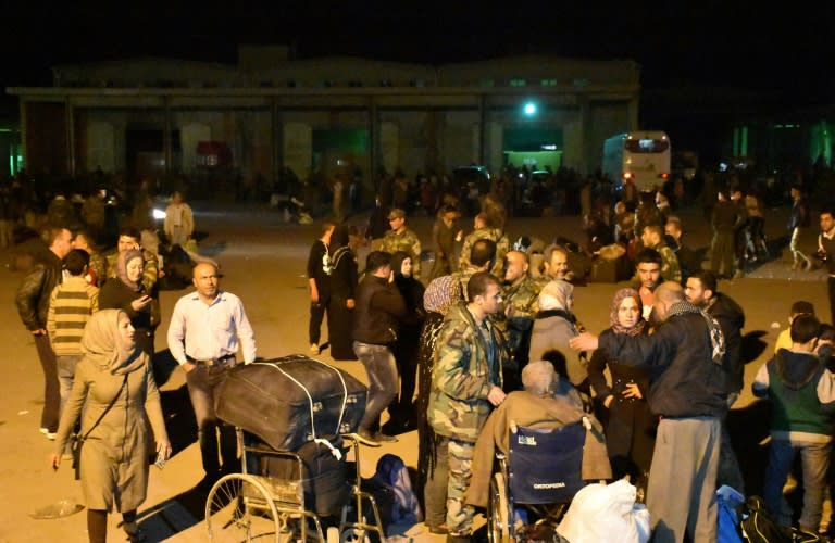 Syrians, evacuated from the besieged government-held towns of Fuaa and Kafraya, arrive in Jibrin on April 15, 2017