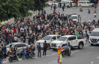 Supporters of pro-democracy gather at Victory Monument in Bangkok, Thailand, Wednesday, Oct. 21, 2020. Student activists applied to a Bangkok court Wednesday to revoke a state of emergency the government declared last week to try to rein in Thailand's growing protests. Demonstrations have continued daily in a movement that calls for Prime Minister Prayuth Chan-ocha to step down, for a more democratic constitution and for reforms to the monarchy — a revered institution traditionally treated as sacrosanct in Thailand. (AP Photo/Sakchai Lalit)