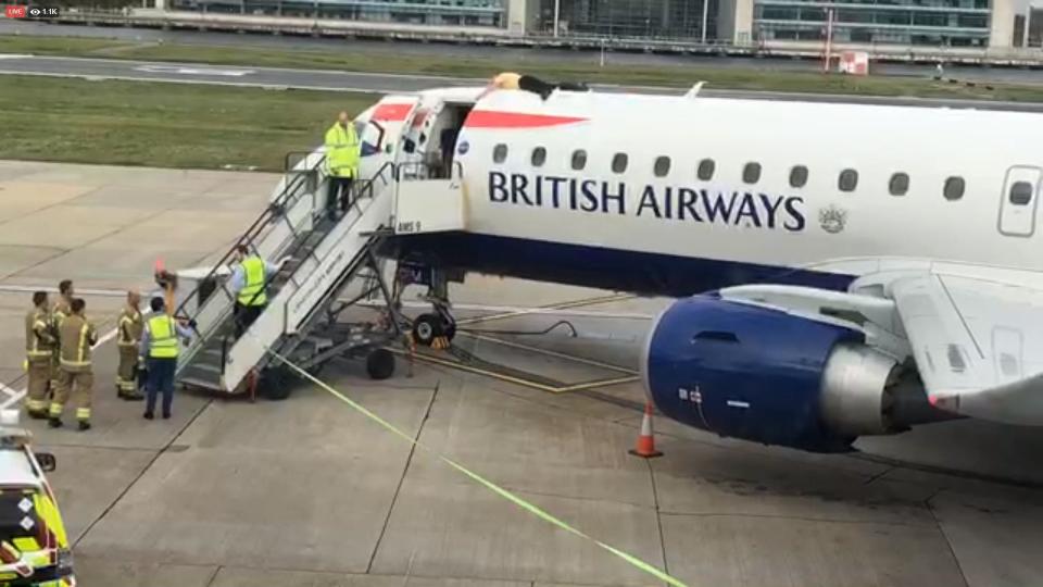 Former Paralympian James Brown lying on top of a British Airways plane at City Airport, London (Extinction Rebellion/PA) (PA Media)