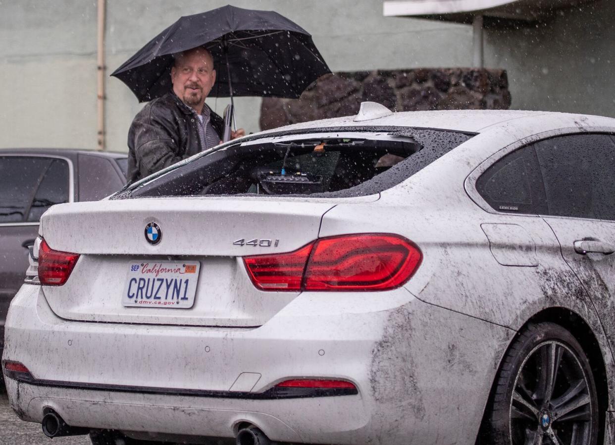 The rear window of a car is blown out from the weather event Wednesday.