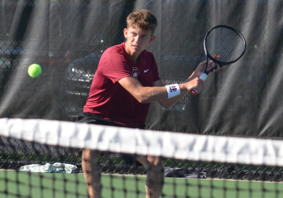 Holland Christian's Josh Dawson returns a shot against Holland on Monday, Sept. 9, 2024, at the Tiger Teusink Tennis Courts at Holland High School.