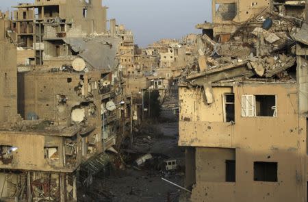 FILE PHOTO - A view shows damaged buildings in Deir al-Zor, eastern Syria February 19, 2014. Picture taken February 19, 2014. REUTERS/Khalil Ashawi