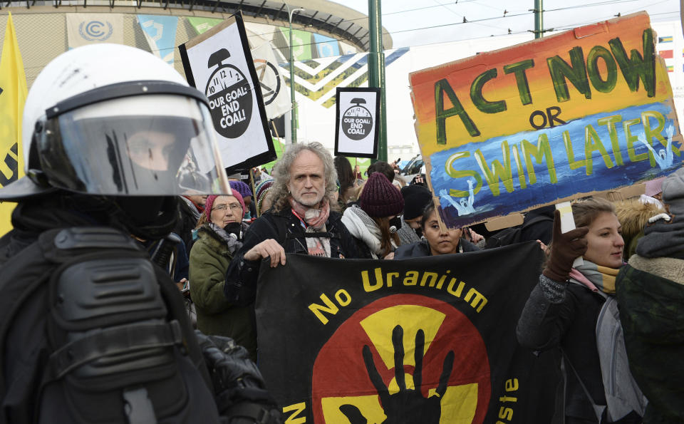 Climate activists stop in front of the COP24 UN Climate Change Conference venue during the March for Climate in a protest against global warming in Katowice, Poland, Saturday, Dec. 8, 2018. (AP Photo/Alik Keplicz)