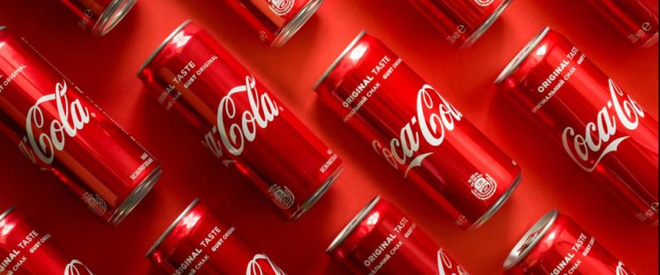 Close-up of Coca Cola drink jars lying on paper background.