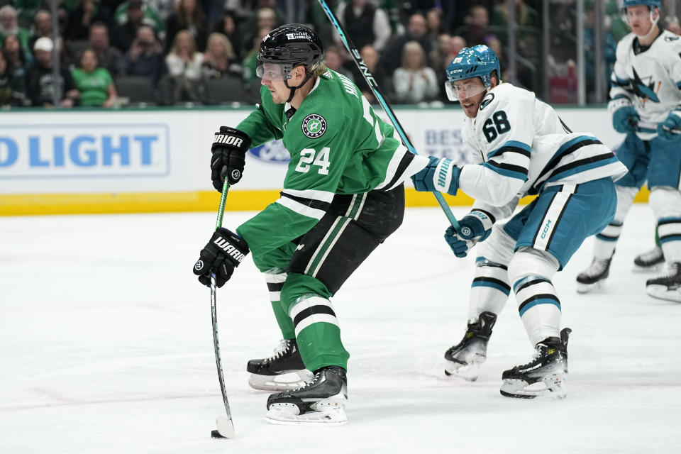 Dallas Stars center Roope Hintz (24) lines up a shot as San Jose Sharks' Mike Hoffman (68) defends during the first period of an NHL hockey game in Dallas, Saturday, March 2, 2024. (AP Photo/Tony Gutierrez)