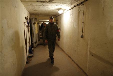 Marco, dressed as NVA officer, inspects the bunker during the 'reality event' one night at the 'Bunker-Museum' in Rennsteighoehe near the eastern city of Ilmenau October 12, 2013. REUTERS/Ina Fassbender