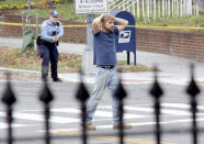 FILE - Edgar Maddison Welch, of Salisbury, N.C., surrenders to police in Washington on Dec. 4, 2016. Comet Ping Pong was targeted in the “Pizzagate” conspiracy, which apparently originated on Twitter and led an armed Welch to burst into the restaurant in 2016 to investigate the claims. Welch later pleaded guilty to illegally transporting firearms over state lines and assault with a dangerous weapon. He was sentenced to four years in prison. (Sathi Soma via AP, File)