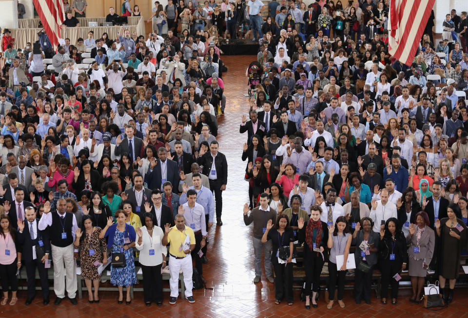 Immigrants take the oath of citizenship to the United States in the Great Hall of Ellis Island