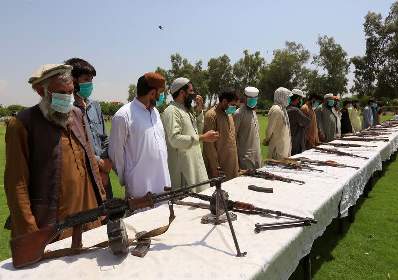 FILE PHOTO: Members of the Taliban handover their weapons and join in the Afghan government's reconciliation and reintegration program in Jalalabad, Afghanistan