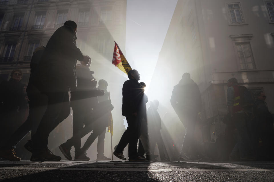 Protesters march during a demonstration in Lyon, central France, Thursday, Jan. 16, 2020. Protesters denounced French President Emmanuel Macron's plans to overhaul the country's pension system. (AP Photo/Laurent Cipriani)