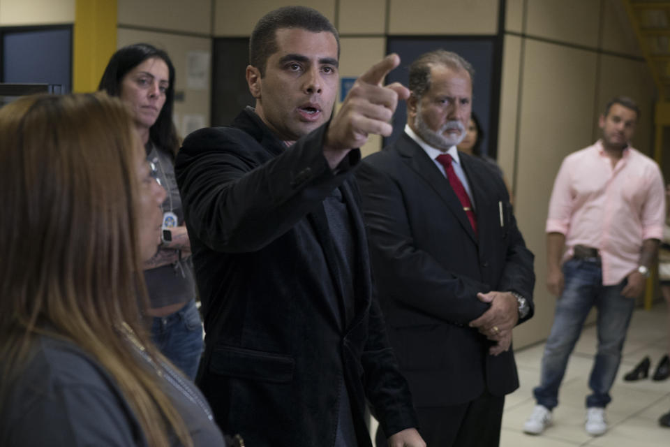 <em>Dr Furtado points to a journalist for the next question as he addresses the press at police headquarters after his arrest (AP)</em>