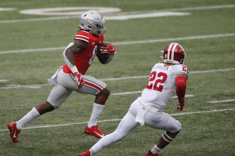 Ohio State running back Trey Sermon, left, cuts up field against Indiana defensive back Jamar Johnson during the first half of an NCAA college football game Saturday, Nov. 21, 2020, in Columbus, Ohio. (AP Photo/Jay LaPrete)