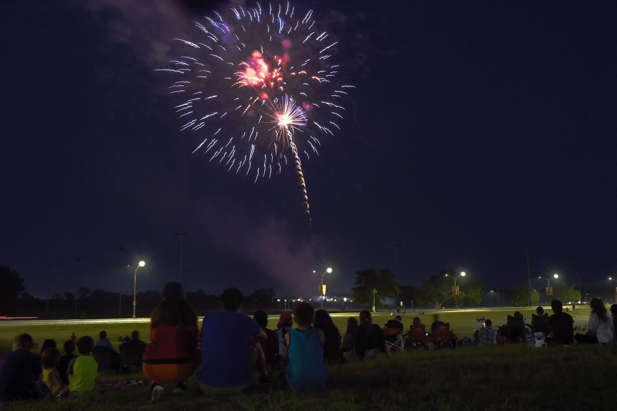 People watch the fireworks in the Ames sky during the 4th of July celebration at Jack Trice Stadium Saturday, July 3, 2021.