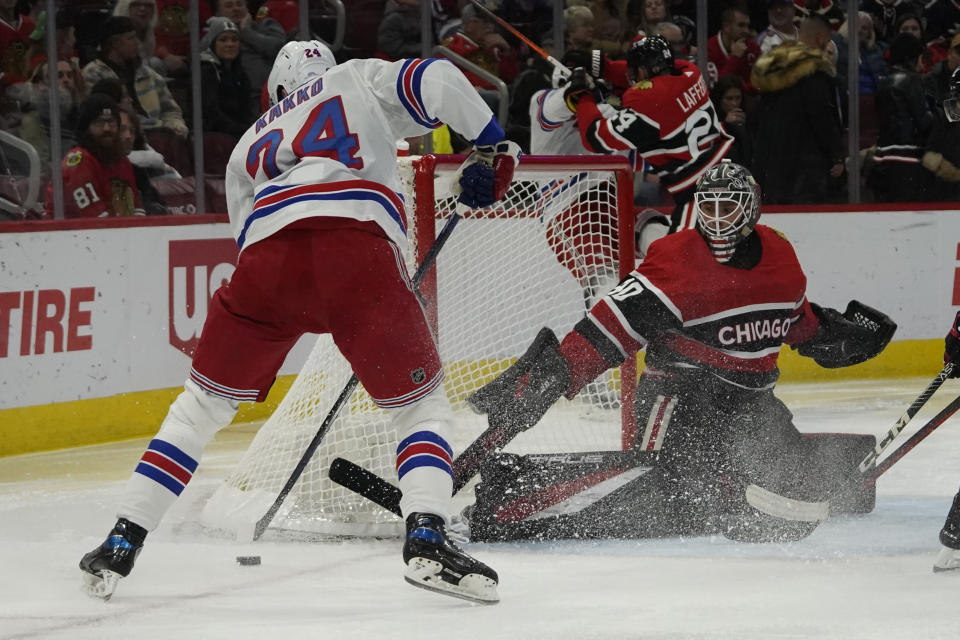 New York Rangers right wing Kaapo Kakko shoots the puck on Chicago Blackhawks goaltender Arvid Soderblom (40) during the second period of an NHL hockey game, Sunday, Dec. 18, 2022, in Chicago. (AP Photo/David Banks)