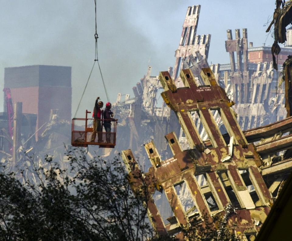 Workmen begin the task of dismantling the destroyed remains World Trade Centre building (EPA)