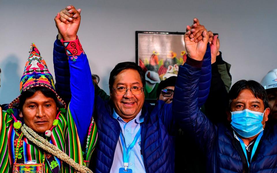 Bolivia's leftist presidential candidate Luis Arce (centre) - RONALDO SCHEMIDT/AFP via Getty Image