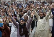 Supporters of Tehreek-e-Labiak Pakistan, a radical Islamist political party, chant slogans during a sit-in protest against the arrest of their party leader Saad Rizvi and demanding to expel the French envoy from the country, in Lahore, Pakistan, Friday, April 16, 2021. Pakistan briefly blocked access to all social media on Friday, after days of anti-French protests across the country by radical Islamists opposed to cartoons they consider blasphemous. (AP Photo/K.M. Chaudary)