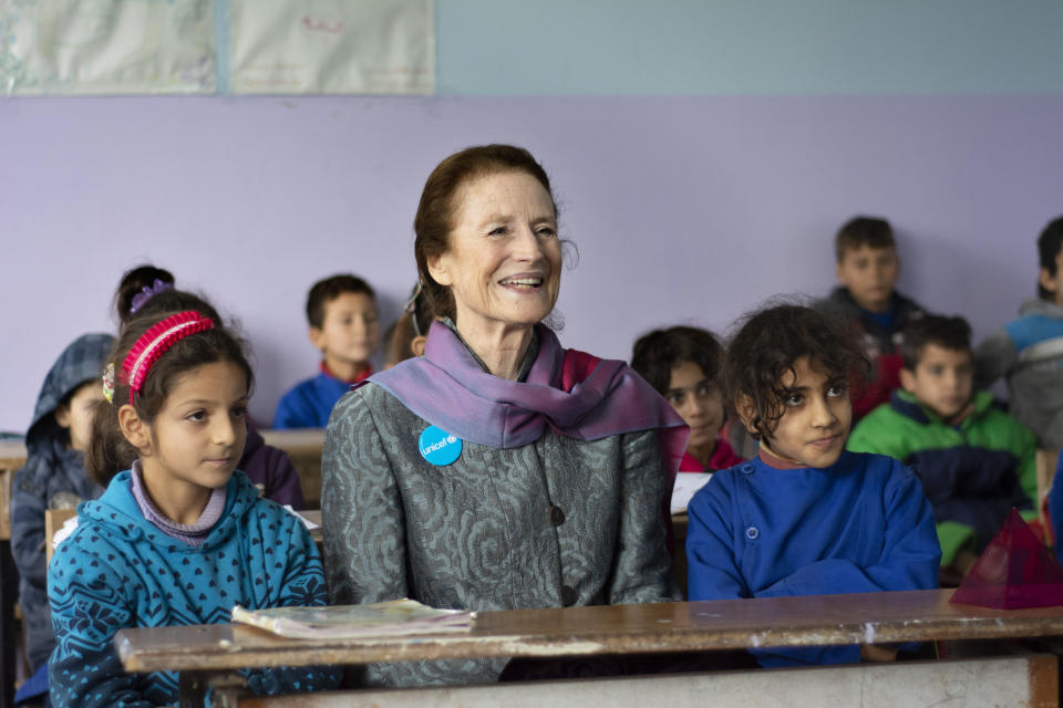 This Tuesday, Dec. 11, 2018 photo provided by UNICEF, shows UNICEF Executive Director Henrietta Fore, sitting with students during her visit to Alexandria school in Ma'ardes, Hama, Syria. In an interview with The Associated Press after returning from a visit to Syria, Fore said Thursday, Dec. 13, 2018, that even though the fighting is winding down, 2 million children inside Syria are still out of schools and it will take years and a lot of funding to help children get over the scars of the seven-year conflict. (UNICEF via AP )