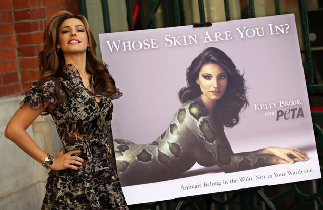 British actress and model Kelly Brook poses beside a poster as she unveils a campaign for People for the Ethical Treatment of Animals (PETA) in London, on September 15, 2011. The advertising campaign shows Brook painted like a snake to highlight the trade in the skins of exotic animals and is launched on the eve of London Fashion Week. AFP PHOTO / ADRIAN DENNIS