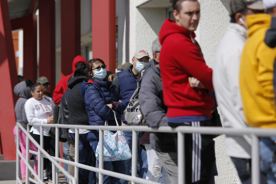 People wait in line for help with unemployment benefits at the One-Stop Career Center, Tuesday, March 17, 2020, in Las Vegas. Nevada Department of Employment, Training and Rehabilitation and its partner organizations, like the One-Stop Career Center, have seen an increase in traffic due to the coronavirus. (AP Photo/John Locher)