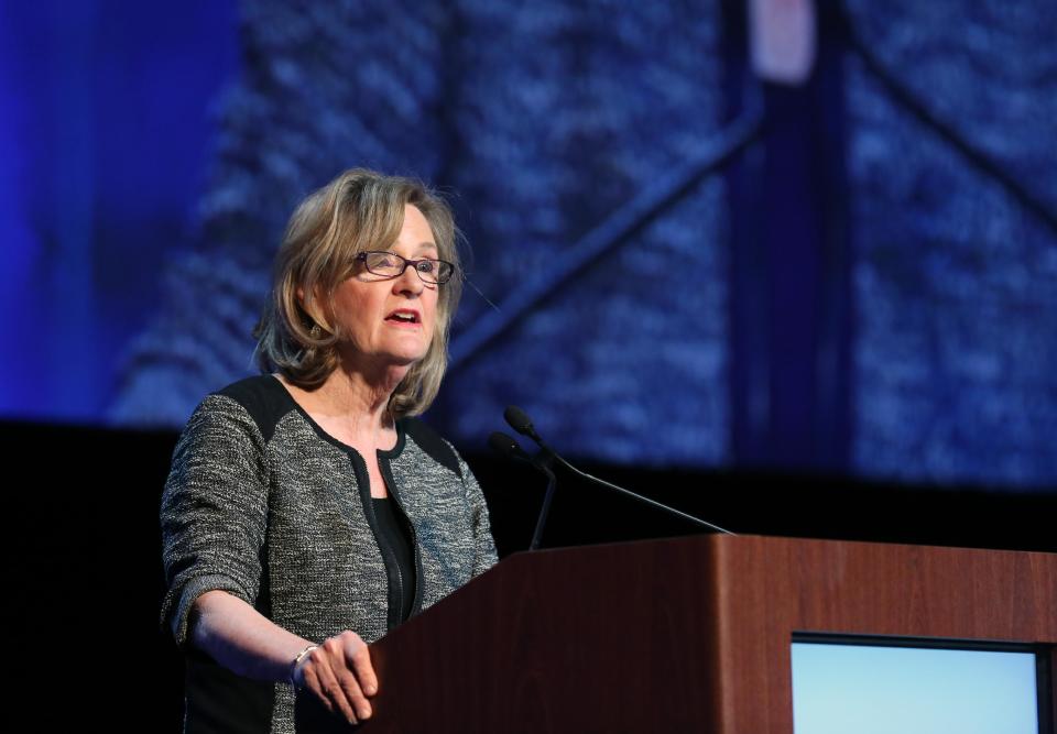 Mary Junck, chairman of AP’s board of directors and CEO of Lee Enterprises, Inc. speaks to fellow editors and publishers at the Newspaper Association of America’s mediaXchange 2014 convention in Denver, Tuesday, March 18, 2014. (AP Photo/Brennan Linsley)