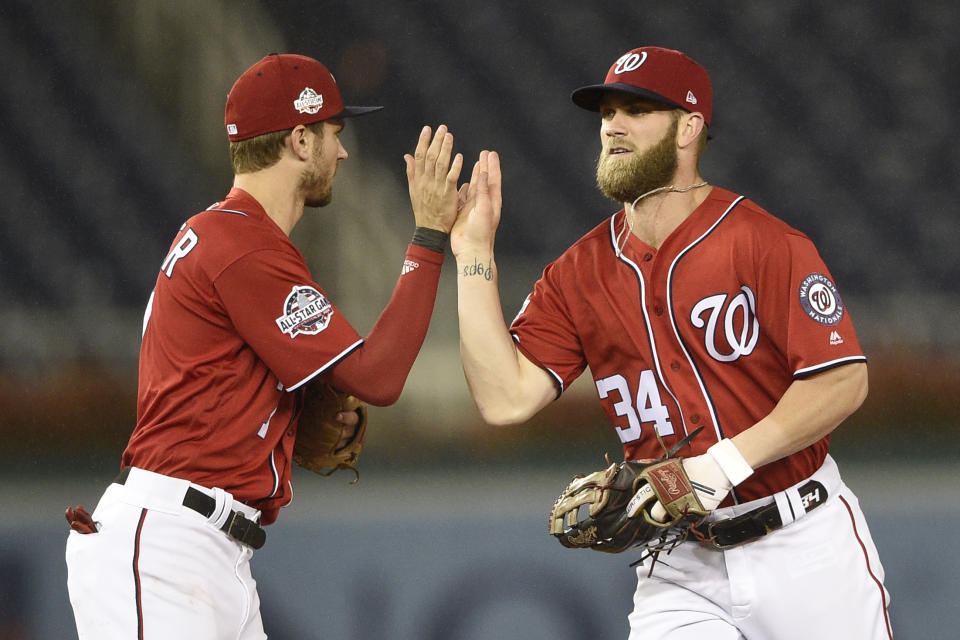 Washington Nationals' Bryce Harper celebrates with Trea Turner, left, after the second baseball game of a doubleheader against the Chicago Cubs, early Sunday, Sept. 9, 2018, in Washington. The Nationals won 6-5. (AP Photo/Nick Wass)