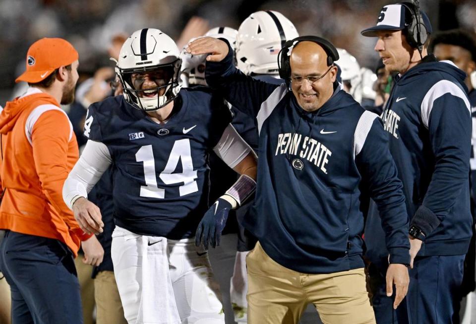 Penn State quarterback Sean Clifford and coach James Franklin celebrate a touchdown during the game on Saturday, Nov. 26, 2022.