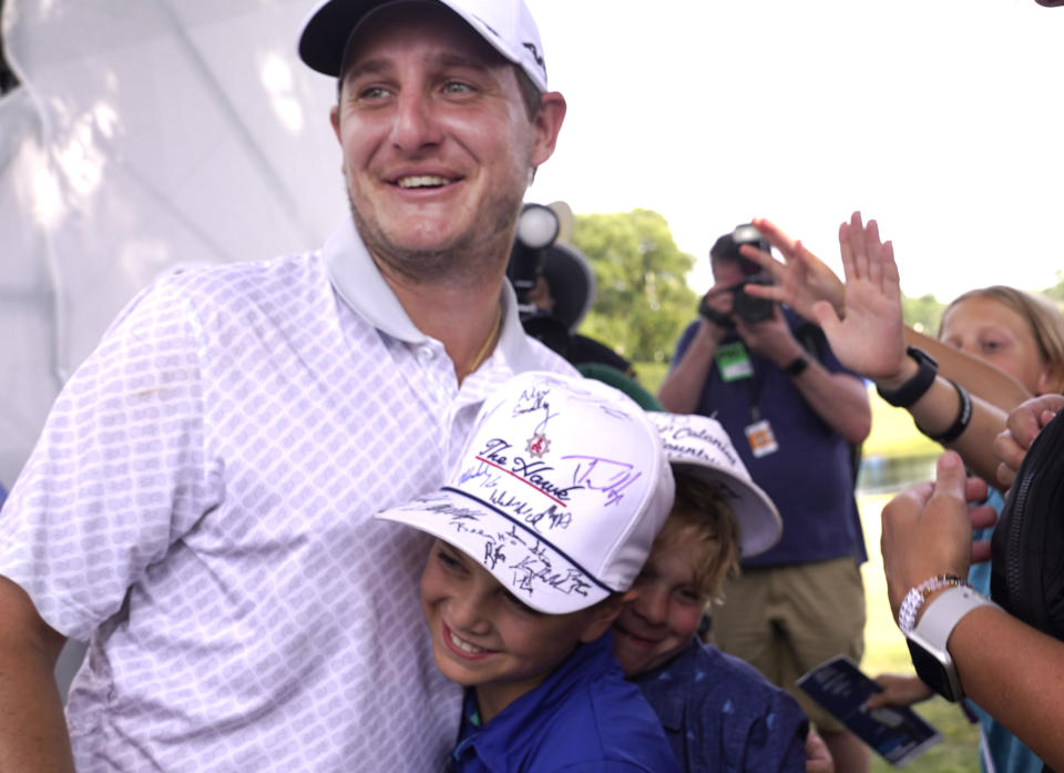 Emiliano Grillo, of Argentina, is hugged after winning a playoff on the 16th hole during the final round of the Charles Schwab Challenge golf tournament at Colonial Country Club in Fort Worth, Texas, Sunday, May 28, 2023. (AP Photo/LM Otero)