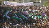 An image from the Syrian opposition Shaam News Network shows people carrying the coffins of people said to have been killed during an offensive by government troops in Daraa. The new head of Syria's main opposition group called Sunday for mass defections from a Syrian regime struggling to survive by carrying out massacres, as the death toll in the uprising topped 14,000