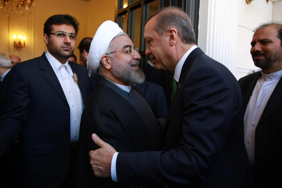 Iranian President Hassan Rouhani, second left, welcomes Turkish Prime Minister Recep Tayyip Erdogan for their meeting in Tehran, Iran, Wednesday, Jan. 29, 2014. Erdogan arrived in Tehran for talks with Iranian leaders on bilateral ties and regional issues including Syria. (AP Photo/Ebrahim Noroozi)