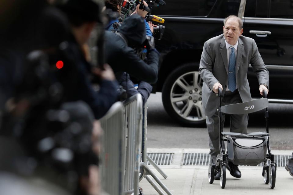 Harvey Weinstein greets reporters as he arrives at court for jury instructions in his sex-crimes trial in New York, Feb. 18, 2020.
