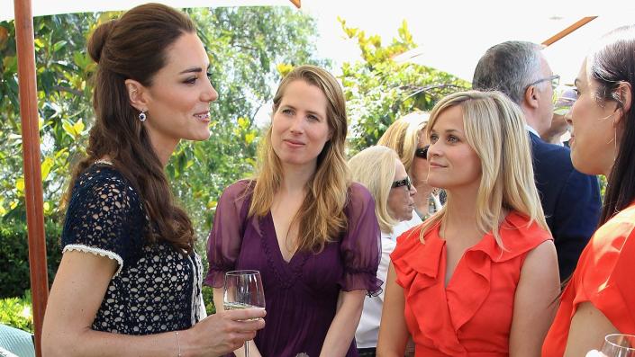 Reese Witherspoon staring at Kate Middleton as she speaks to a crowd