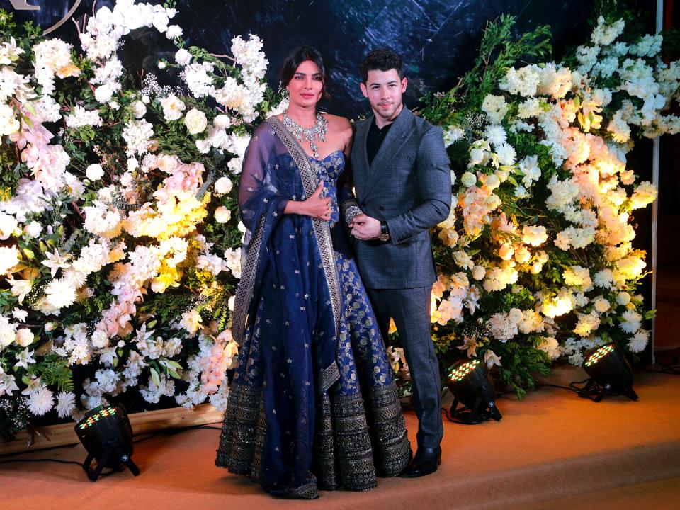 Priyanka Chopra and Nick Jonas posing at their wedding celebration in Mumbai, December 2018.