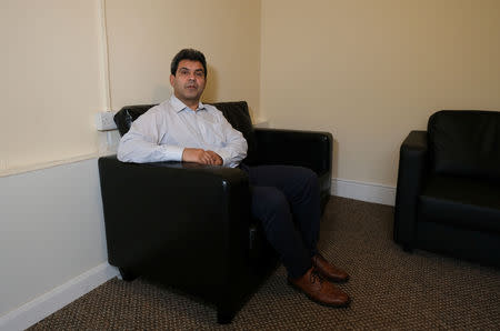 Iranian asylum seeker Mohammad Salehi Bakhtiari poses for a photograph at his home in Liverpool, Britain January 14, 2019. REUTERS/Andrew Yates