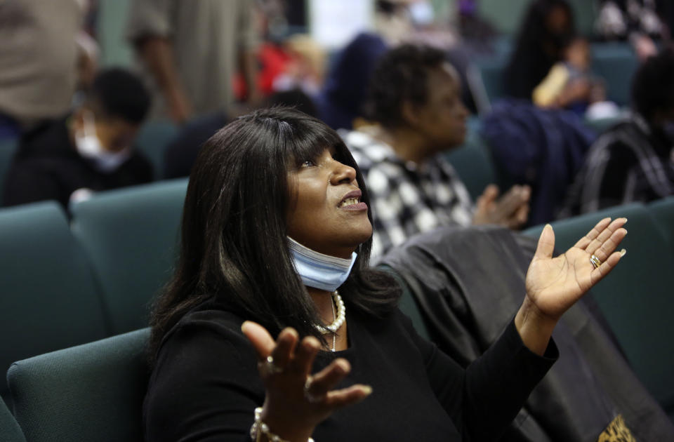 A congregant of the Faith Center Church lifts her hands toward the sky as she worships with others in Bluefield, W.Va., on Saturday, Jan. 24, 2021. (AP Photo/Jessie Wardarski)