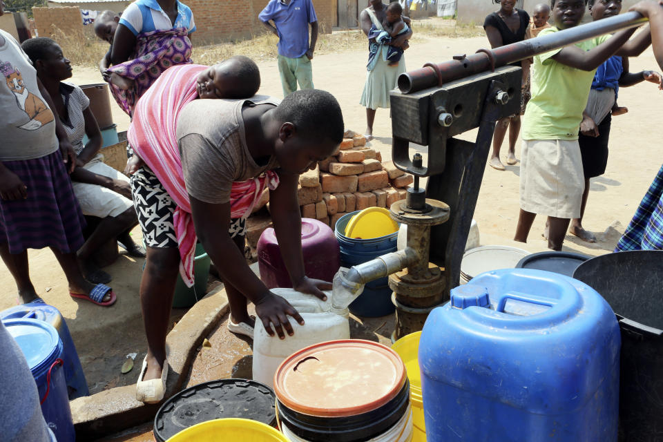 Residents of Epworth wait to fetch water at a borehole in Harare, Tuesday, Sept, 24, 2019.The more than 2 million residents of Zimbabwes capital and surrounding towns are now without water after authorities shut down the citys main treatment plant, raising new fears about disease after a recent cholera outbreak while the economy crumbles further.(AP Photo/Tsvangirayi Mukwazhi)