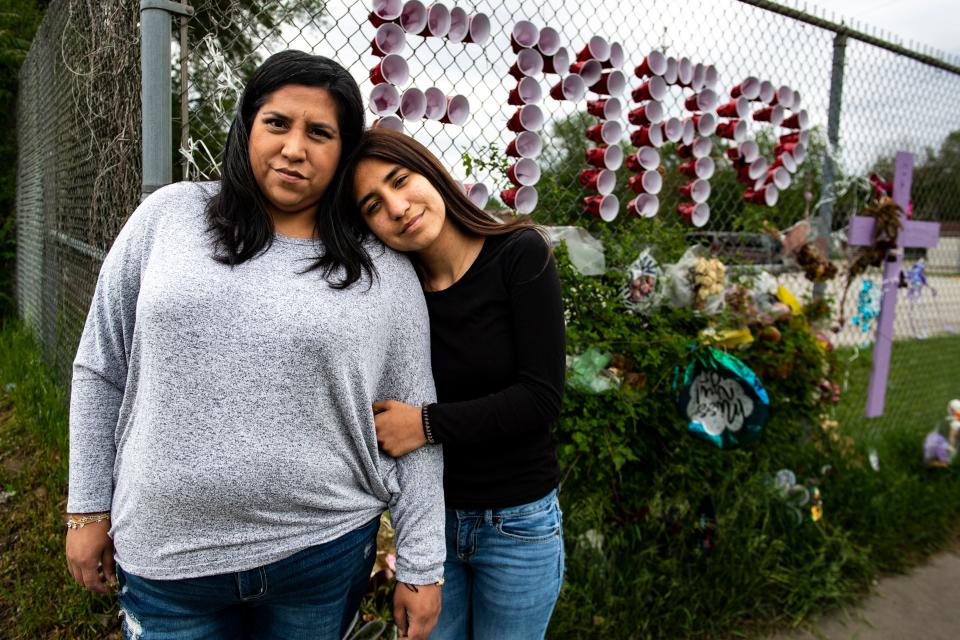 Anna Campos and her daughter Nayelli Sandoval, 16, pose for a photo near a makeshift memorial for 14-year-old Ema Cardenas, Campos' daughter and Nayelli's sister, on East University Avenue, where the girl was killed in a hit-and-run accident April 28.