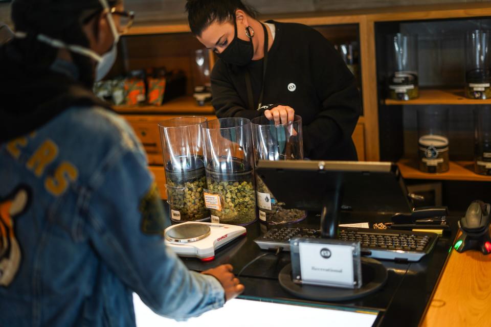 Common Citizen dispensary adviser DeeAnn Edgley helps fill an order at Common Citizen dispensary in Flint, Mich., on April 22. The business sells medical and recreational marijuana products.