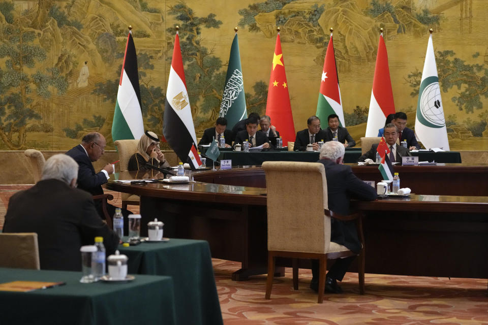 Chinese Foreign Minister Wang Yi, far right, Saudi Arabia's Foreign Minister Prince Faisal bin Farhan Al Saud, third left, and Egyptian Foreign Minister Sameh Shoukry, second left, listen to a speech by Palestinian Foreign Minister Riyad al-Maliki, foreground center, during a round table meeting at the Diaoyutai state guesthouse in Beijing, Monday, Nov. 20, 2023. Wang welcomed five Arab and Islamic counterparts to Beijing on Monday, saying his country would work with "our brothers and sisters" in the Arab and Islamic world to try to end the fighting in Gaza as soon as possible. (AP Photo/Andy Wong)