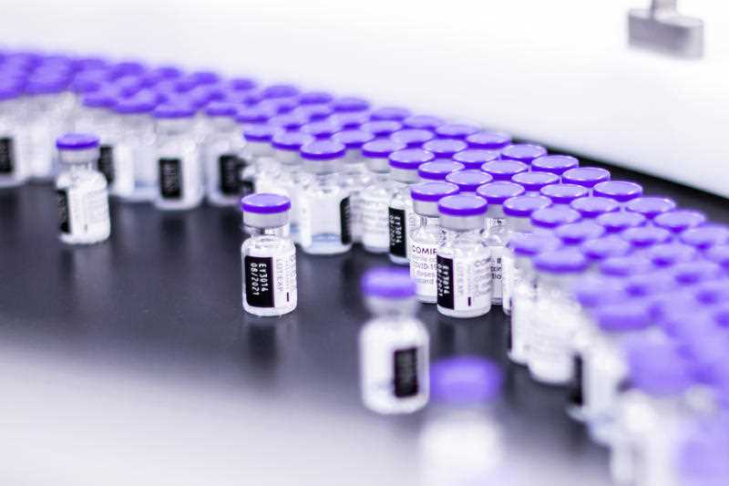Vials of the Pfizer-BioNTech COVID-19 vaccine are prepared for packaging at the company’s facility in Puurs, Belgium.
