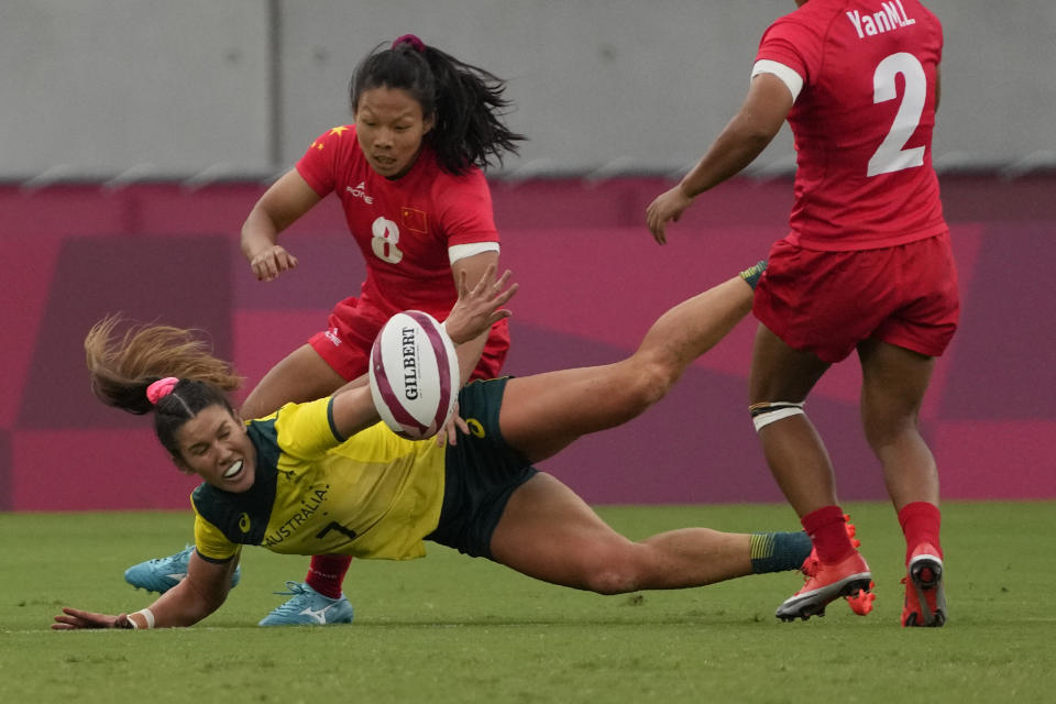 Australia's Charlotte Caslick, bottom, bales with China's Liu Xiaoqian, in their women's rugby sevens match at the 2020 Summer Olympics, Thursday, July 29, 2021 in Tokyo, Japan. (AP Photo/Shuji Kajiyama)