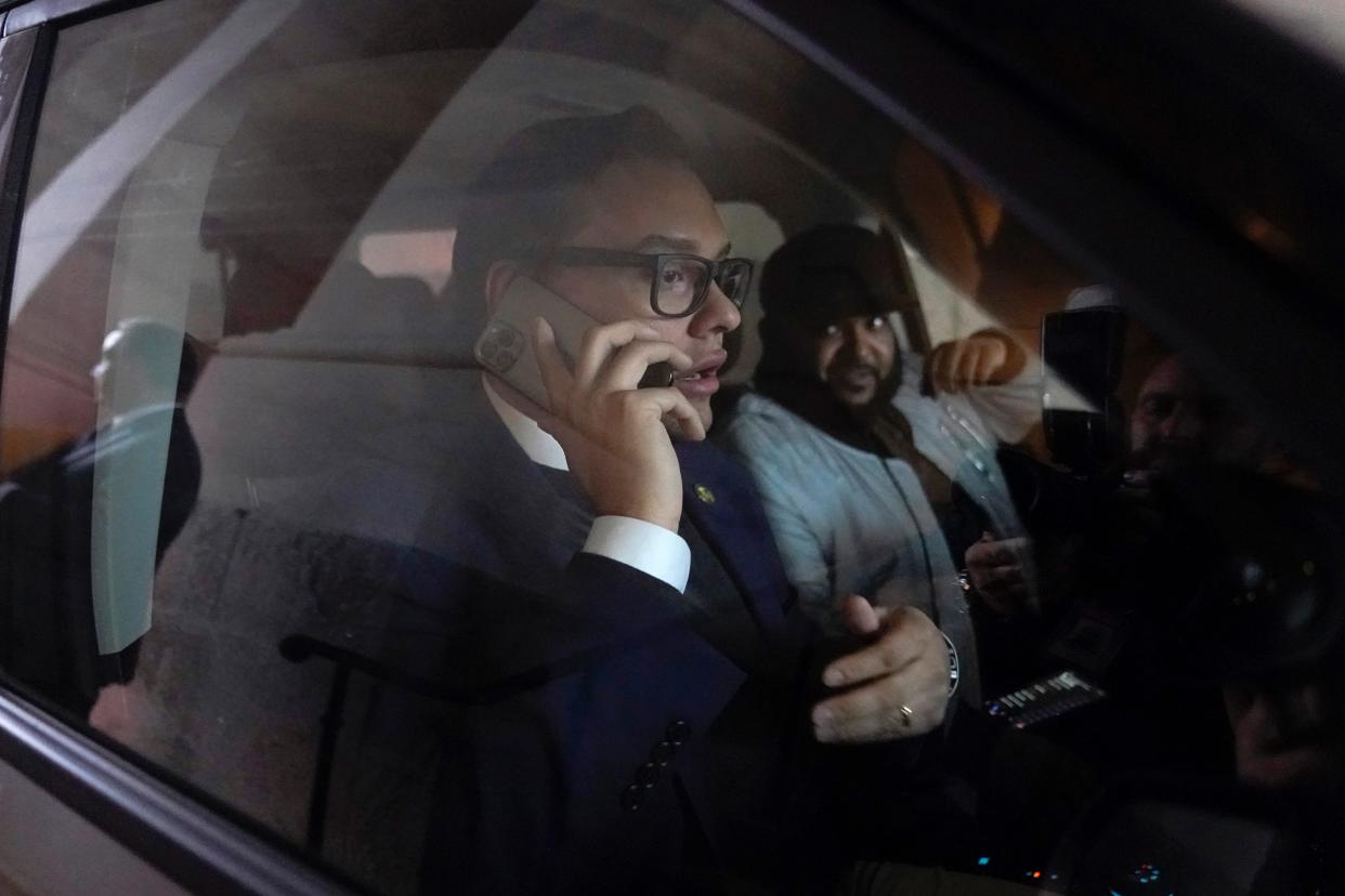 Rep. George Santos, R-N.Y., speaks on a phone as he departs Capitol Hill on Jan. 11.