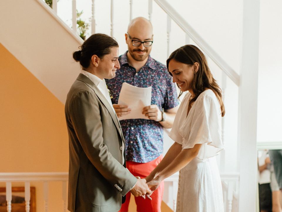 The couple getting married by a friend, with their TikTok-famous dog looking on.