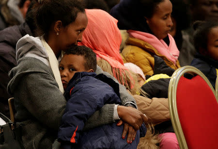 Migrants wait for Pope Francis to lead a special mass to mark International Migrants Day in Saint Peter's Basilica at the Vatican January 14, 2018. REUTERS/Max Rossi